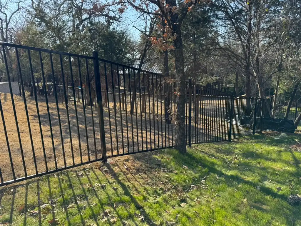 Rackable iron fence panels following a backyard grade