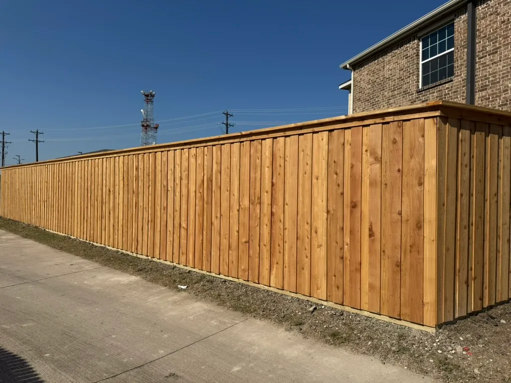 Long board-on-board cedar privacy fence on a large North DFW property