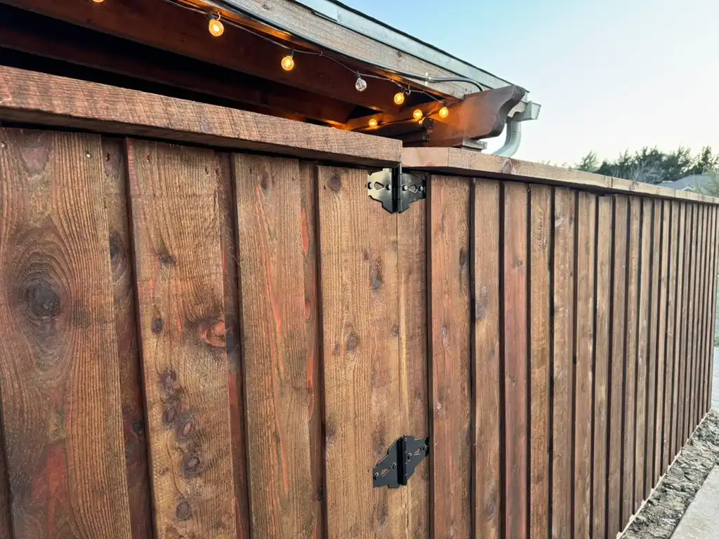 Closeup of top cap and trim joinery on a board-on-board cedar fence