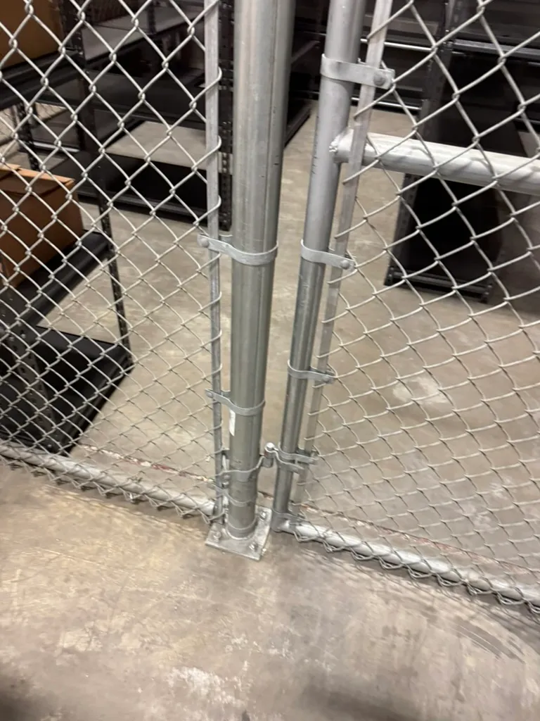 Baseplated commercial chain link fence anchored to concrete