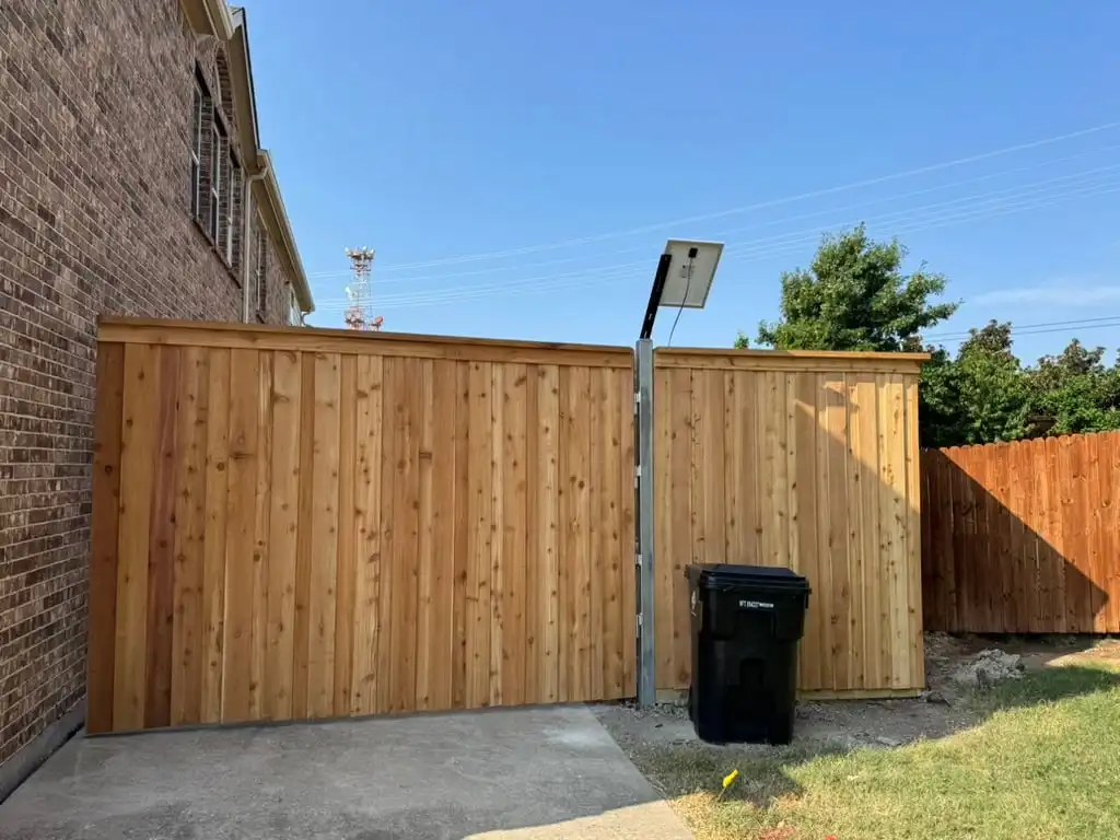Large cedar swing gate with a solar power panel