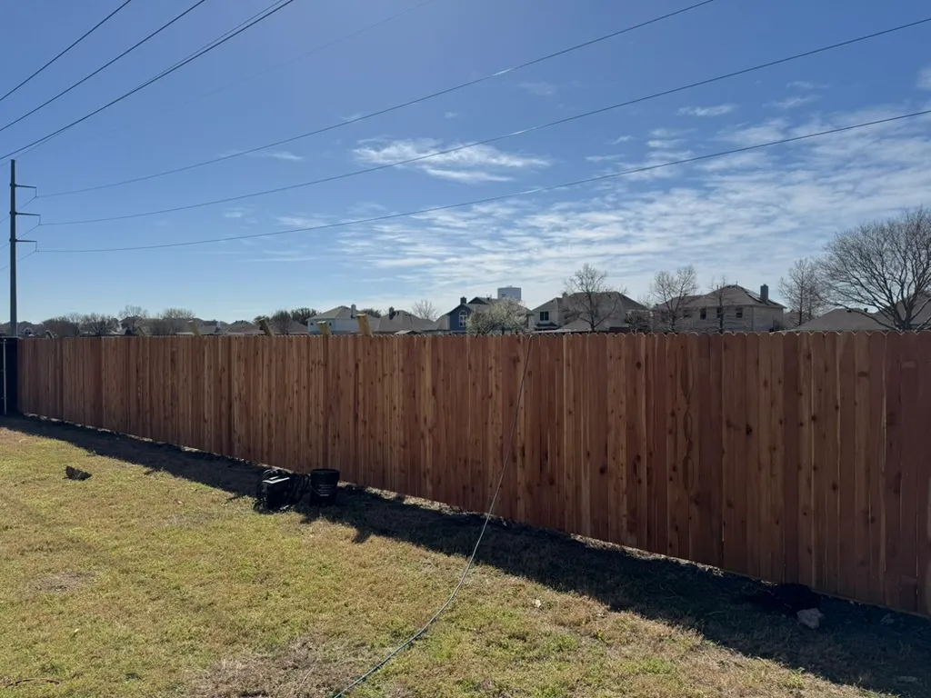 Long side-by-side cedar fence run installed by Kodiak Fence Company on a large lot