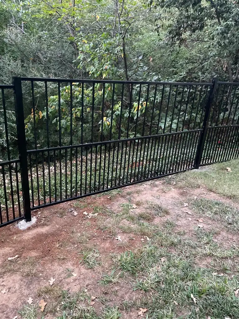 Iron fence with puppy panels for tighter picket spacing