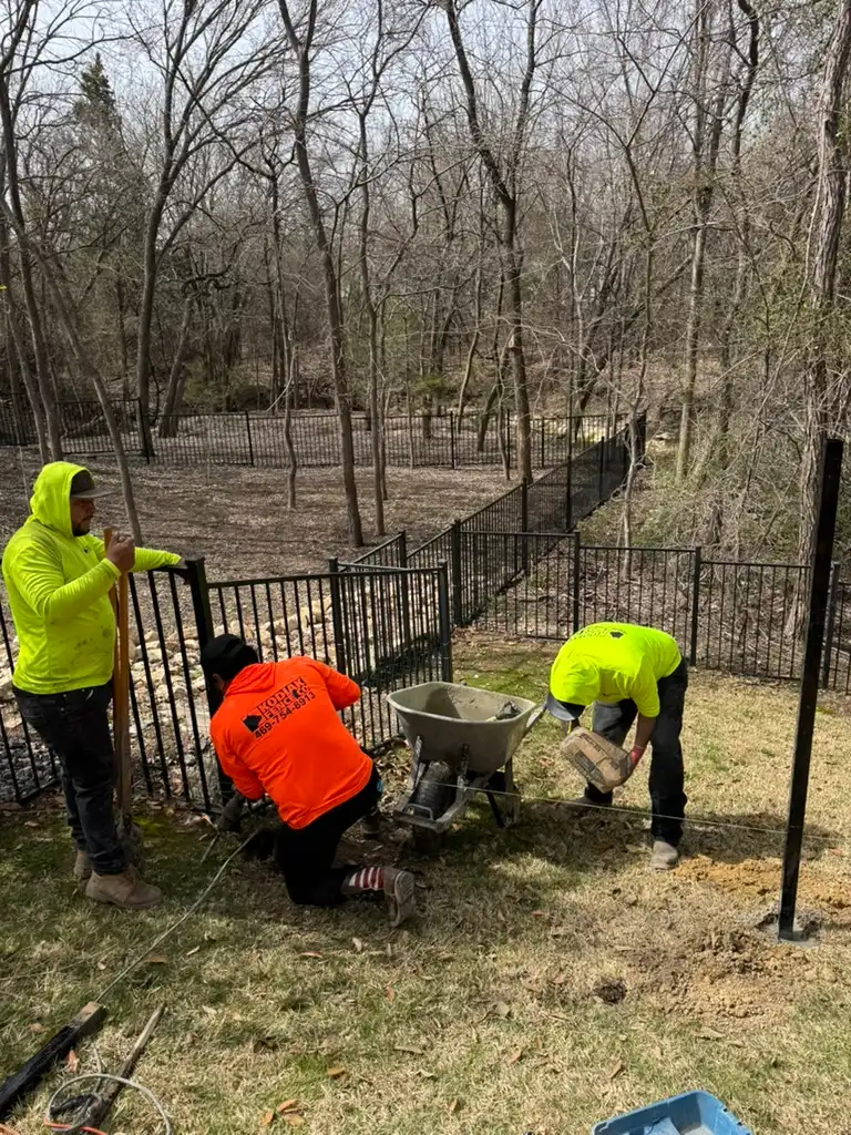 Kodiak crew installing a steel fence on site