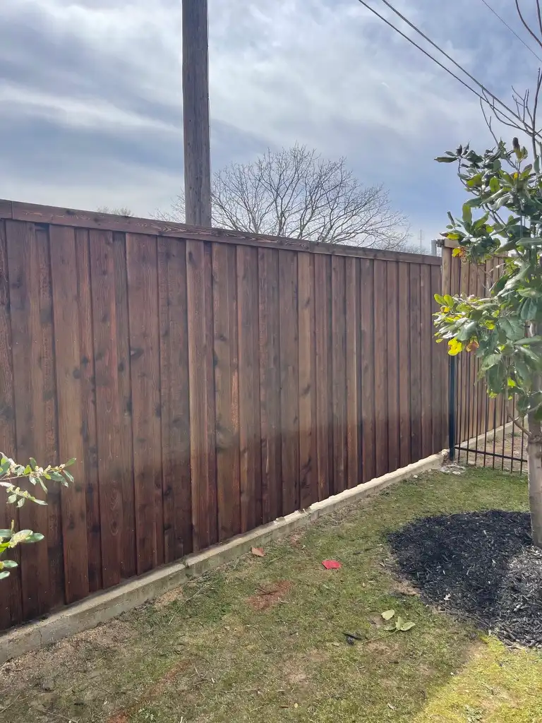 Cedar fence finished in Oxford brown stain