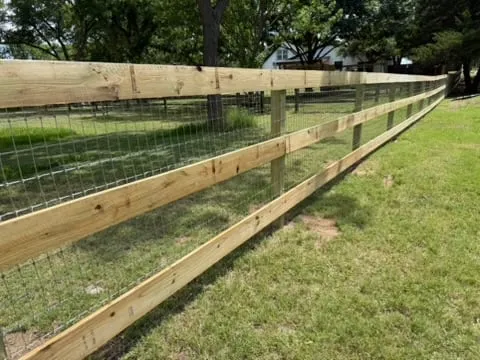 Ranch rail fence with woven horse wire behind the rails