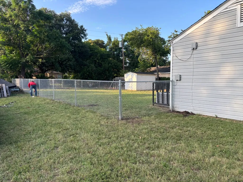 Residential chain link fence installation in progress