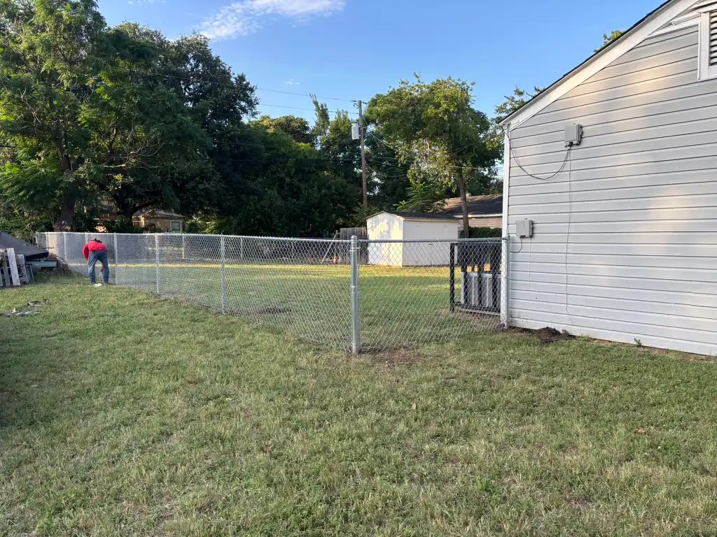 Residential chain link fence installation by the Kodiak Fence Company crew