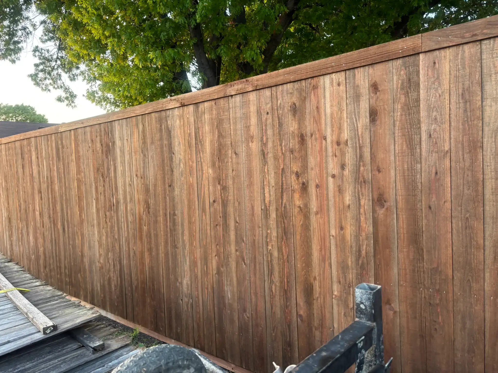 Side-by-side cedar privacy fence with trim detail