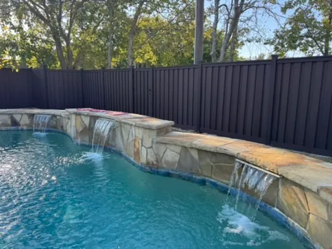 Trex composite fence enclosing a backyard pool