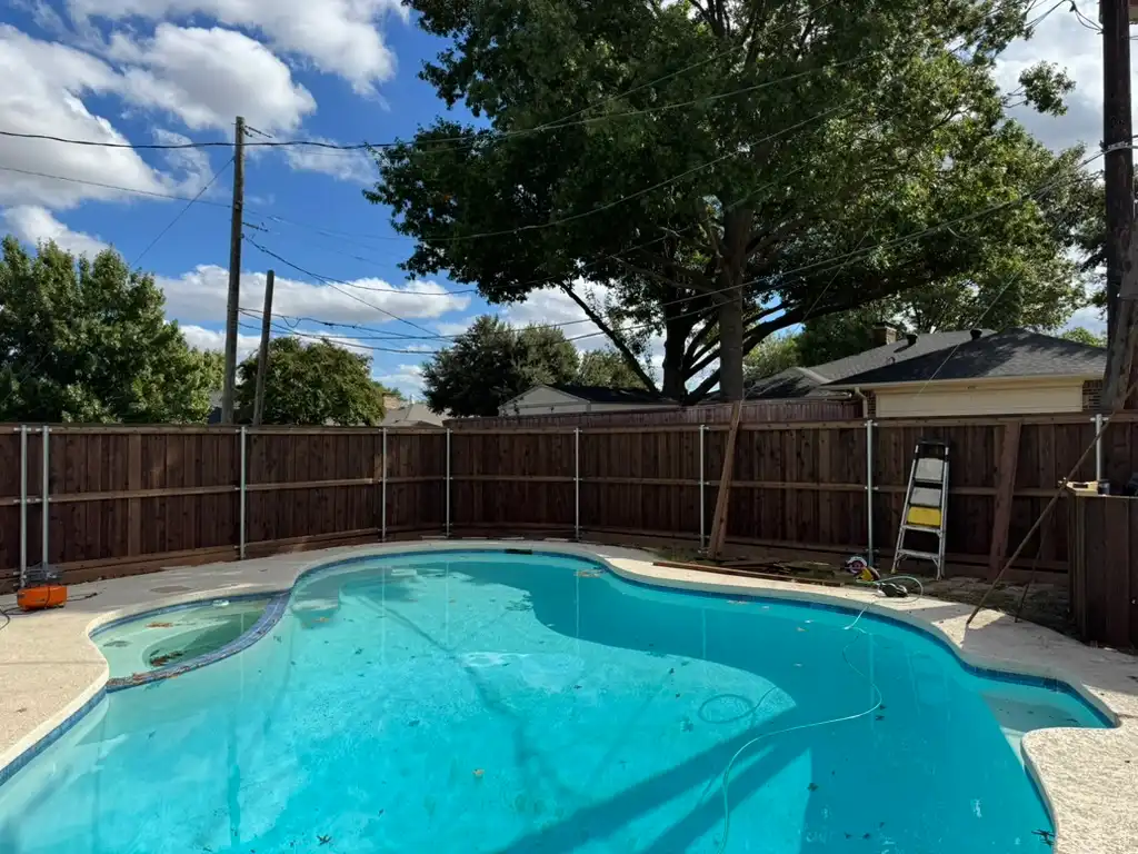 Wood privacy fence enclosing a backyard pool
