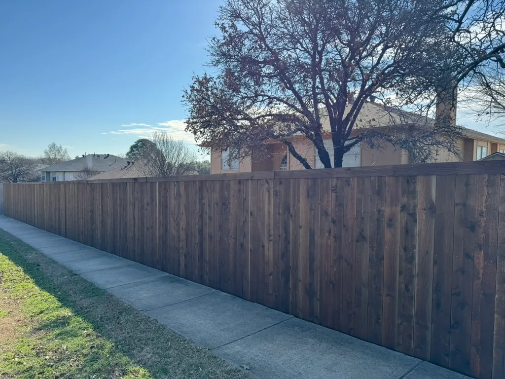 Stained cedar privacy fence after installation